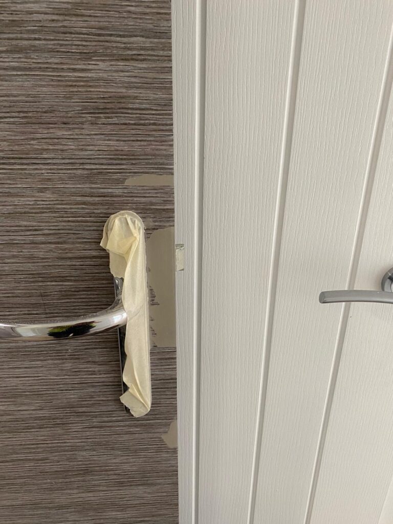 door handle with chipped paint visible