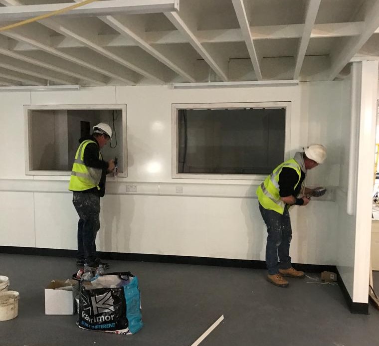 two sealant applicators working on Swansea Bay Hospital