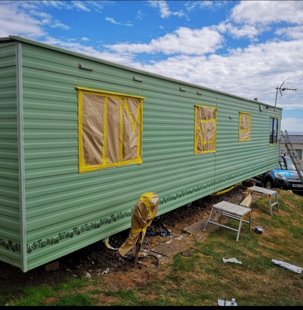 side of a caravan in green