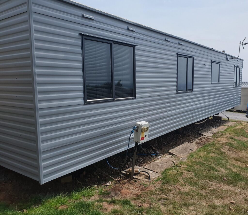 side of a caravan painted grey