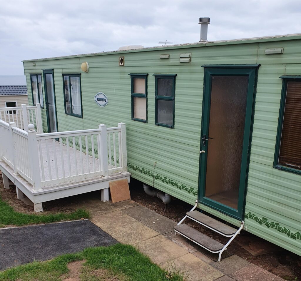 front of a caravan in green