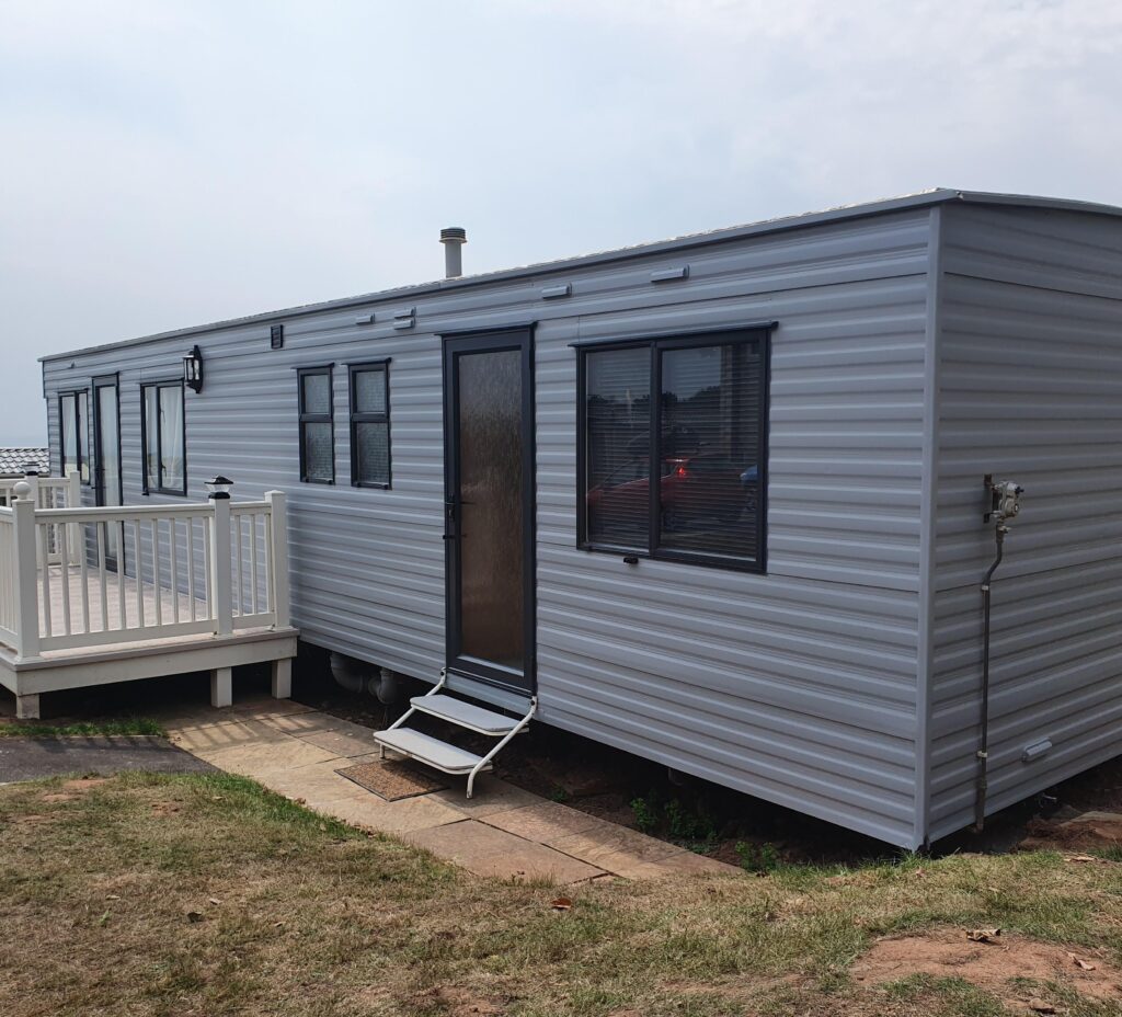 front of a caravan painted grey