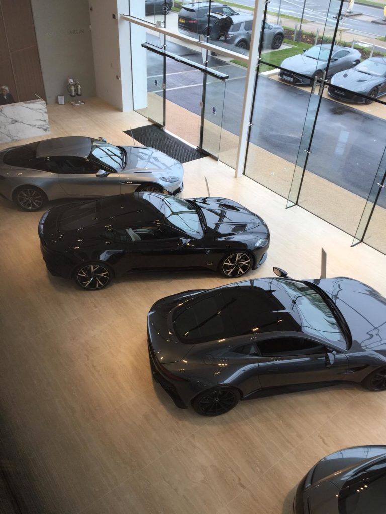 four black cars in a showroom window