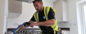 An SD Team member with sealant